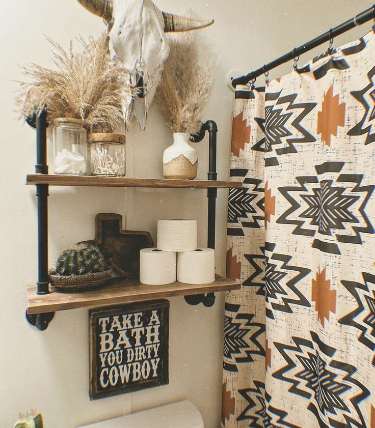 the bathroom is decorated in southwestern style with black, white and brown decor on shelving