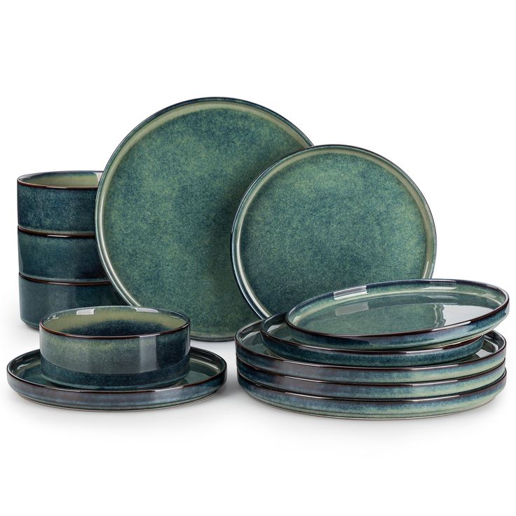 a set of green dishes with black rims