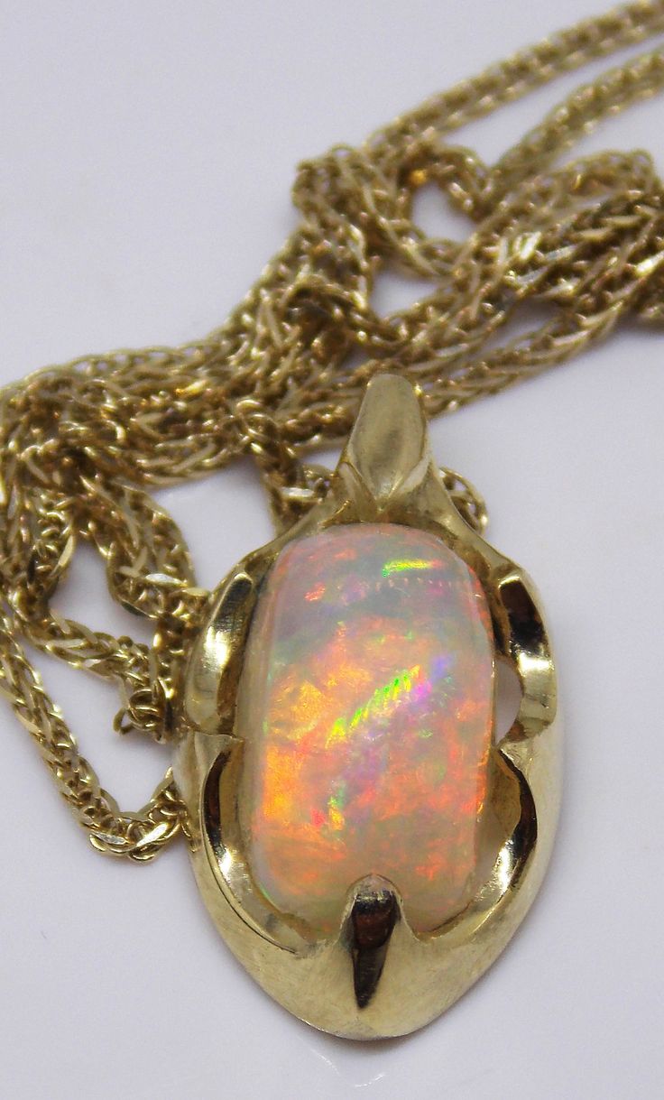 "One of a kind top quality handmade stunning 14k gold Welo 1.8ct AAA opal pendant!! It is an especially precious item, a rare gift to someone that you cherish, a powerful expression of love and friendship. Surprise your special someone with this spectacular opal pendant! This amazing, large opal rainbow boasts a colorful floral pattern with vibrant color rainbow color that changes with every gentle motion. Indirect sunlight, it looks really glamorous and replaces colors .... A truly joyous stone Opal Cabochon Yellow Gold Jewelry, Yellow Gold Opal Cabochon Jewelry, Unique Yellow Gold Opal Necklaces, Unique Yellow Gold Ethiopian Opal Jewelry, Unique Yellow Gold Opal Necklace, Yellow Gold Ethiopian Opal Cabochon Jewelry, Formal Gold Ethiopian Opal Jewelry, Formal Ethiopian Opal Gold Jewelry, Gold Ethiopian Opal Cabochon Jewelry