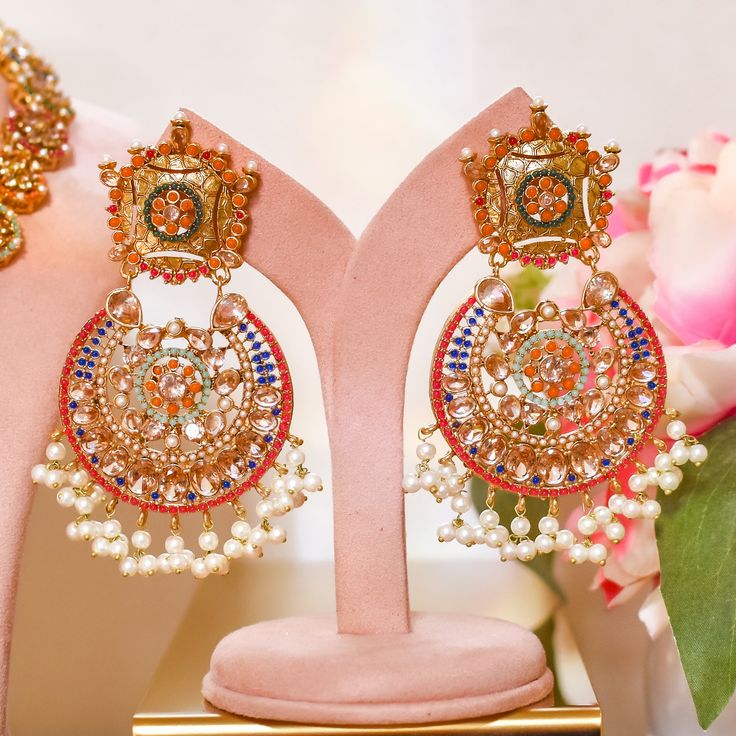 Adorn into the extravagant fusion of grace and royalty! Paint yourself in luscious shades of nauratan stones enhanced by pearl moti hanging with a classic embodiment of ravishing design radiating elegant femininity. Approximate earrings length is 4". Gold-plated on high-quality brass as base metal. Iqra Earrings (Sapphire) is in-stock & ready-to-ship. Delivery time frame for other options is 5-7 weeks. For custom or urgent requests, please contact support@alacouture.com. *Please Note: The multi-