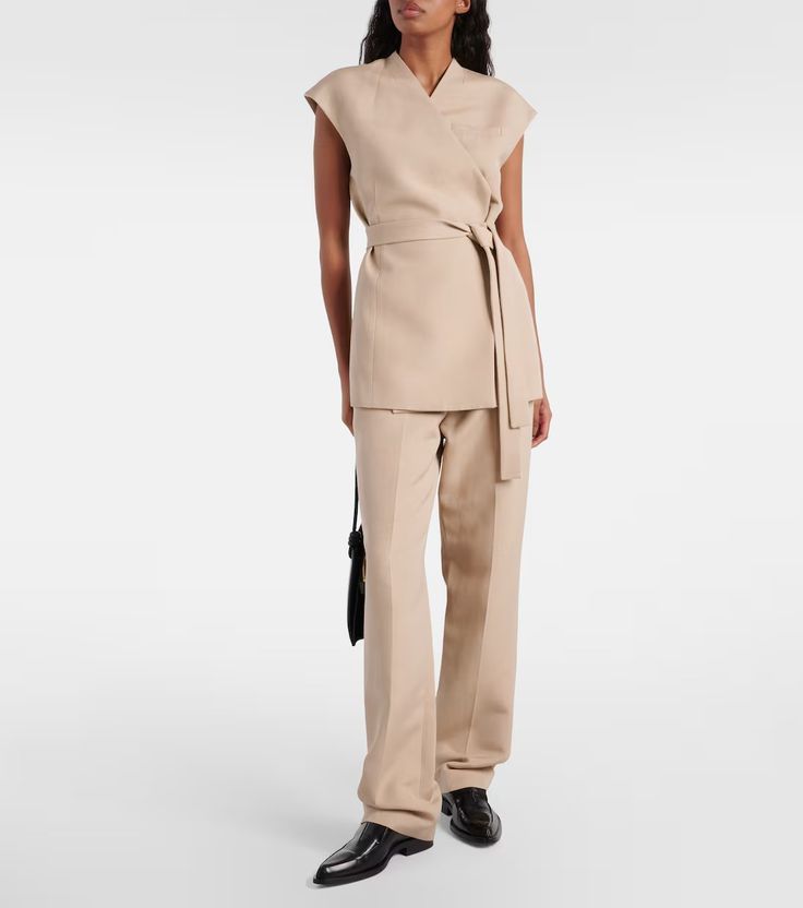 Bonnie cotton-blend vest in beige - Tove | Mytheresa Sleeveless Cotton Workwear Vest, Elegant Cotton Sleeveless Blouse Vest, Beige Vest For Work, Beige Workwear Vest, Fitted Cotton Vest For Workwear, Tailored Beige Tops For Work, Chic Sleeveless Cotton Outerwear, Cotton V-neck Vest For Daywear, Beige V-neck Vest For Work