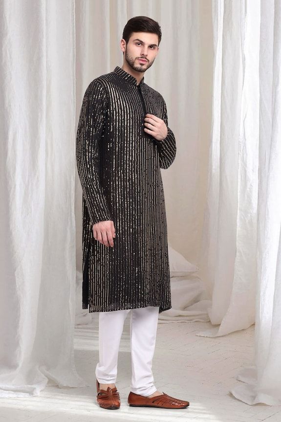 Black kurta with striped sequin work embroidery. Paired with solid churidaar. - Aza Fashions Traditional Festive Kurta With Sequins, Traditional Festive Sequined Kurta, Traditional Straight Kurta With Sequins, Unstitched Traditional Wear With Sequins For Eid, Unstitched Sequined Traditional Wear For Eid, Bollywood Style Straight Kurta With Sequins, Festive Celebration Kurta With Mirror Work, Bollywood Style Sequined Straight Kurta, Traditional Sequined Wear For Eid