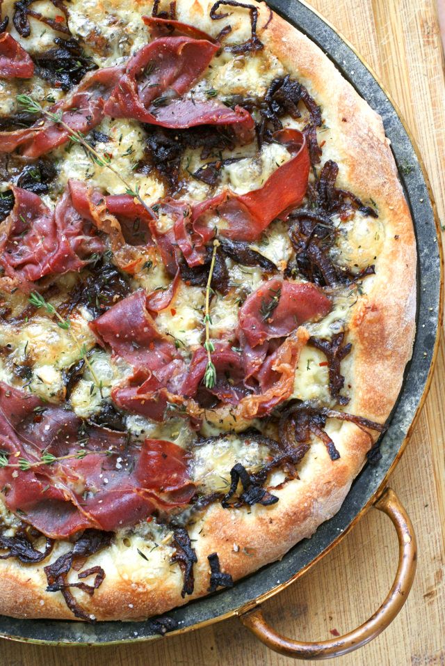 a pizza sitting on top of a pan covered in toppings