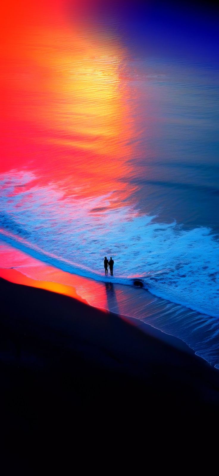 two people are standing on the beach at sunset with their backs turned to the ocean