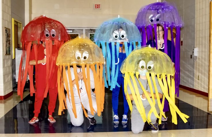 several jellyfish with eyes and legs are lined up