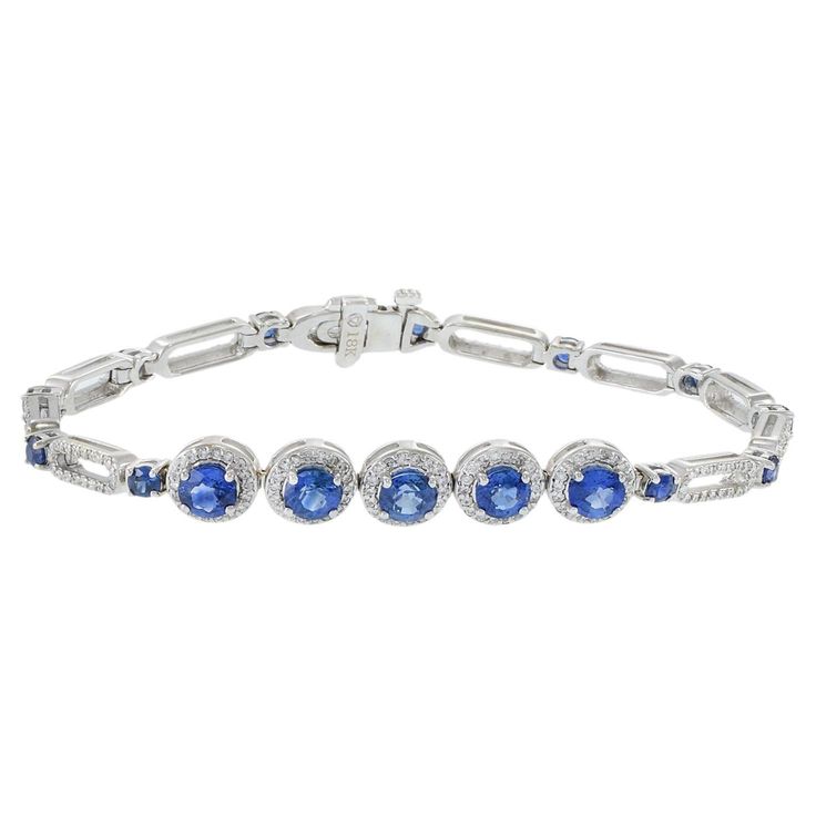 This elegant 18KT white gold bracelet features a total of 3.00CT of round-cut genuine Ceylon blue sapphires, adding a vivid and captivating touch. The sapphires are beautifully complemented by 1.56 carats total weight of G-VS/SI round-cut diamonds, set in the finest 18KT white gold. This combination of vibrant blue sapphires and sparkling diamonds creates a sophisticated and luxurious accessory, making it a timeless addition to any jewelry collection. Elegant White Gold Sapphire Diamond Bracelet, Luxury Blue Sapphire Bracelets, Luxury Sapphire Diamond Bracelet, Luxury Sapphire Jubilee Bracelet, Luxury Sapphire Diamond Bracelet, Brilliant Cut, 77 Diamonds, Ceylon Blue Sapphire, Diamond Huggie Earrings, Ruby Bracelet