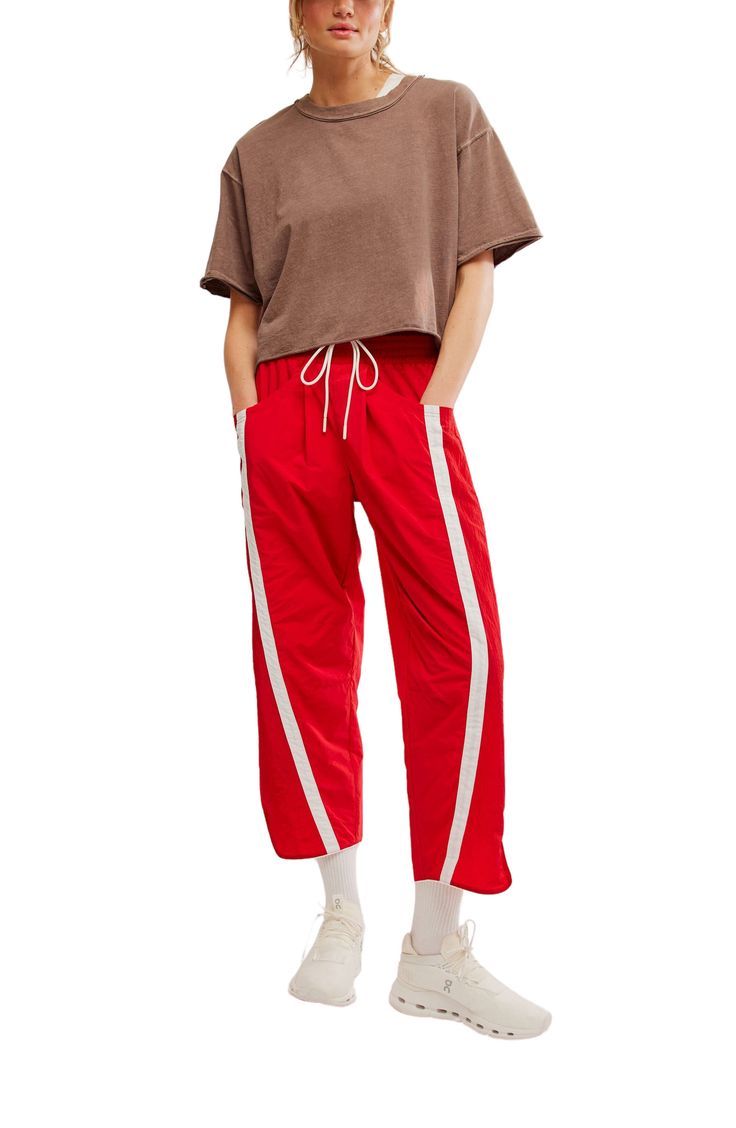 Traditionally sporty track attire gets a street-style reset in these water-resistant nylon pants refreshed with an ultrawide smocked waistband and wavy cropped hems. 25 1/2" inseam; 18" leg opening; 14" front rise; 18" back rise (size Medium) Smocked/drawstring waist Front scoop pockets; back patch pockets Water resistant 100% nylon Machine wash, tumble dry Imported Spring Sportswear Parachute Pants With Relaxed Fit, Relaxed Fit Parachute Pants For Spring Sportswear, Sporty Joggers With Elastic Cuffs For Spring, Sporty Wide Leg Parachute Pants For Summer, Sporty Parachute Pants For Summer Streetwear, Sporty Summer Parachute Pants For Streetwear, Spring Sporty Joggers With Elastic Waistband, Sporty Stretch Cotton Parachute Pants, Sporty Summer Parachute Pants For Loungewear