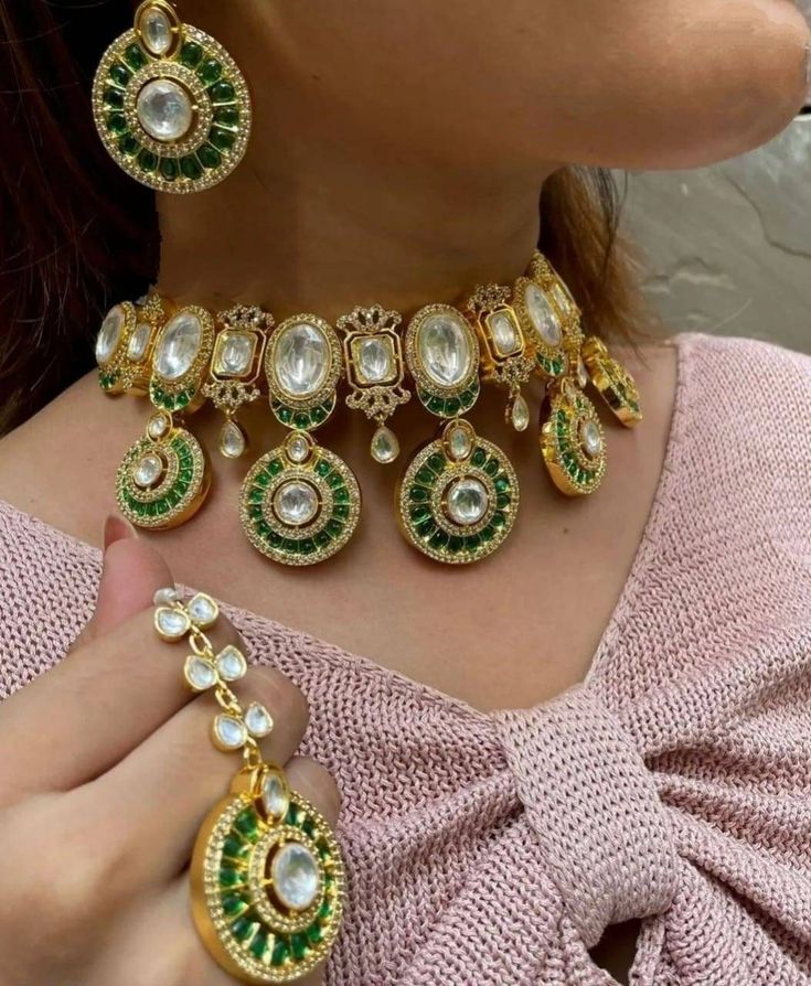 Stunning and gorgeous, silver foiled Kundan and High grade CZ stones studded very fine quality Sabyasachi emerald green necklaces with matching earrings and Maangtikka.  18 K gold plated rhodium plated  Earrings length: Approx 3 inches Earrings Closure: Pushback Necklace Closure: Adjustable Cord Maangtikka Is optional to purchase or not Highest quality and craftsmanship Indian Bridal Necklace, Green Necklaces, Sabyasachi Jewelry, Emerald Green Necklace, Necklace Closure, Kundan Jewellery Set, Sabyasachi Jewellery, Kundan Jewelry, Polki Necklace