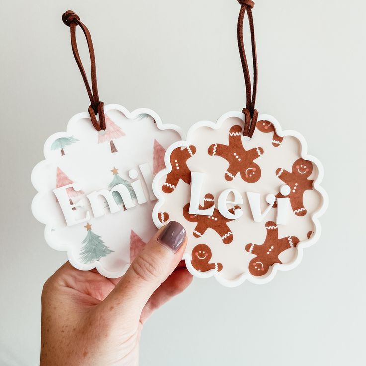 two handmade christmas ornament hanging from strings