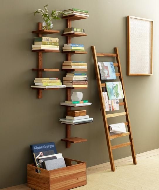 a ladder leaning against a wall next to a bookshelf with several books on it