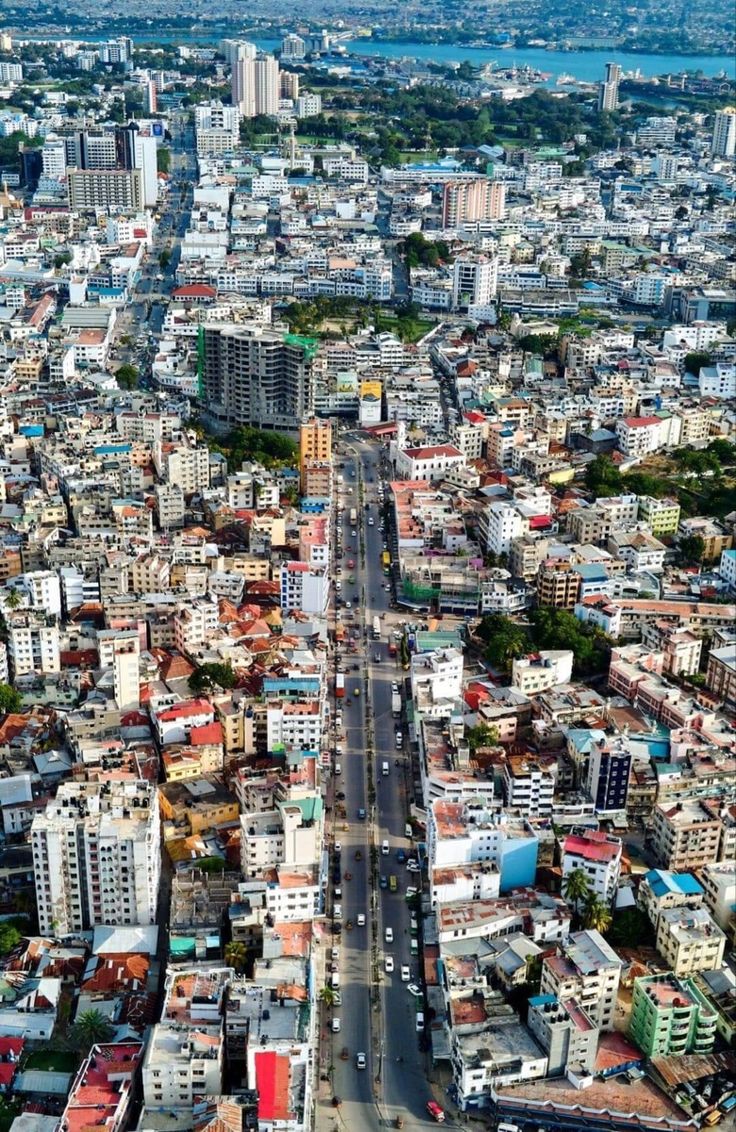 an aerial view of a city with lots of tall buildings and cars driving down the road