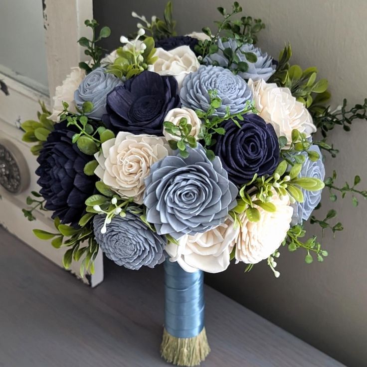 a bridal bouquet with blue and white flowers on a door way entrance matress