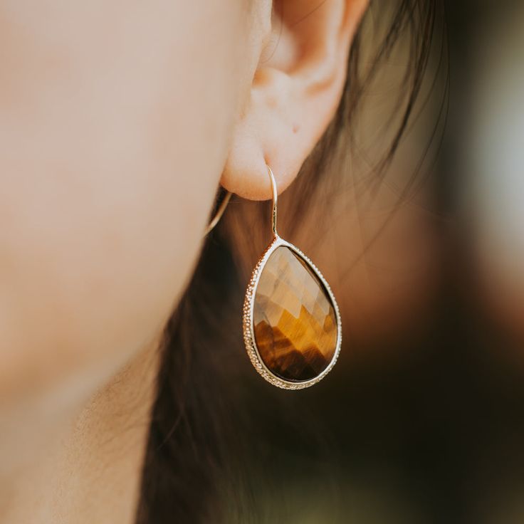 The multifaceted simple design adds a touch of sophistication and elegance to the classic beauty of the Tiger Eye. Material: Tiger Eye Length: 1" Elegant Teardrop Everyday Jewelry, Formal Faceted Teardrop Earrings, Elegant Faceted Teardrop Earrings, Elegant Drop Earrings With Faceted Details, Elegant Faceted Earrings For Party, Elegant Faceted Party Earrings, Faceted Briolette Teardrop Earrings, Minimalist Faceted Drop Earrings, Modern Teardrop Faceted Earrings