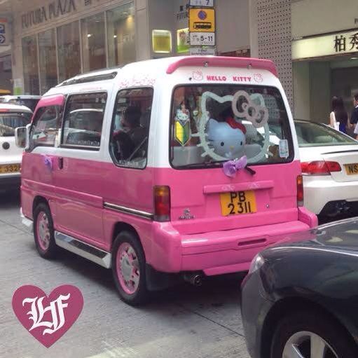 a pink van with hello kitty on the back