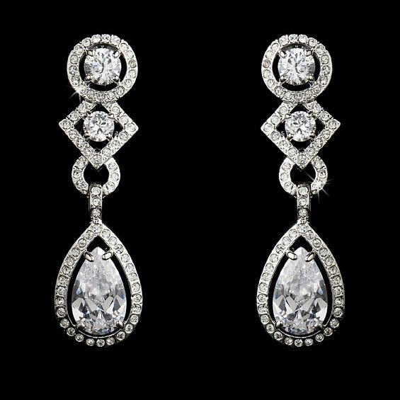 CZ Bridal and Formal EarringsAdd a glamorous touch to your wedding day or special occasion with these sparkling cz earrings. These beautiful cubic zirconia bridal earrings will add lots of sparkle to your bridal look. Available in both pierced and clip on styles, these earrings will be perfect for your special day.Color: Silver plated setting/clear stones.Size: 1.75" long and .5" wide.Style: 3824.Please allow 1 week for delivery.Shipping Policy.Return Policy Cubic Zirconia Bridal Earrings, Wedding Earrings Chandelier, Formal Earrings, Bridal Earrings Chandelier, Simple Silver Jewelry, Dazzling Earrings, Crystal Chandelier Earrings, Clear Earrings, Bridal Fashion Jewelry