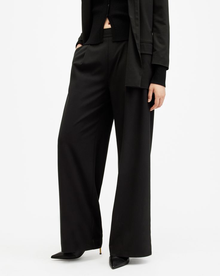 AllSaints tailoring. The Aleida Pants are crafted from a fluid fabric that's super easy to wear. Sitting mid-rise on the waist with flowing wide leg shaping. They've got an easy fit that can easily be taken from day-to-night.   These pants are designed to a regular fit Mid-rise Two side pockets Two back pockets Elasticated waist band Wide leg shape Formal Wear Women, Black Wide Leg Trousers, Office Outfits Women, Work Style, Work Wear Women, Pants And Leggings, Going Out Outfits, Sweater Sale, Sweaters And Jeans