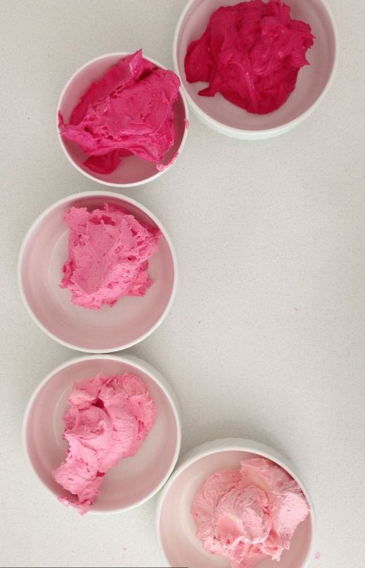 three bowls filled with pink colored food on top of a white table next to each other