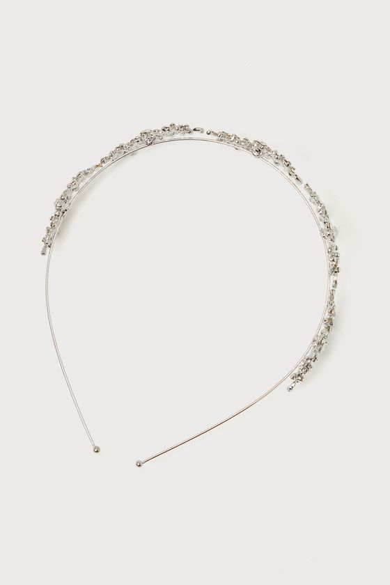 Celebrate big moments as they deserve in a gorgeous piece like the Lulus Sparkling Occasion Silver Rhinestone Headband! Shiny silver-toned metal shapes this darling headband that has a slender wire band. Clusters of glittering rhinestones throughout add a subtle floral effect, for a perfect finishing touch to your most elegant looks. Measures 15. 5" From End To End And 1. 25" Wide. Rhodium Plated Alloy 98%, Rhinestone 2%. Imported. Lulus | Sparkling Occasion Silver Rhinestone Headband. Silver Metal Headpieces For Party, Glamorous Silver Headband For Party, Silver Adjustable Hair Accessories For Formal Occasions, Elegant Adjustable Silver Headpieces, Glamorous Silver Party Headband, Silver Glamorous Party Headband, Glamorous Silver Headband For Wedding, Fitted Silver Headband, Silver Crystal Hair Accessories For Party