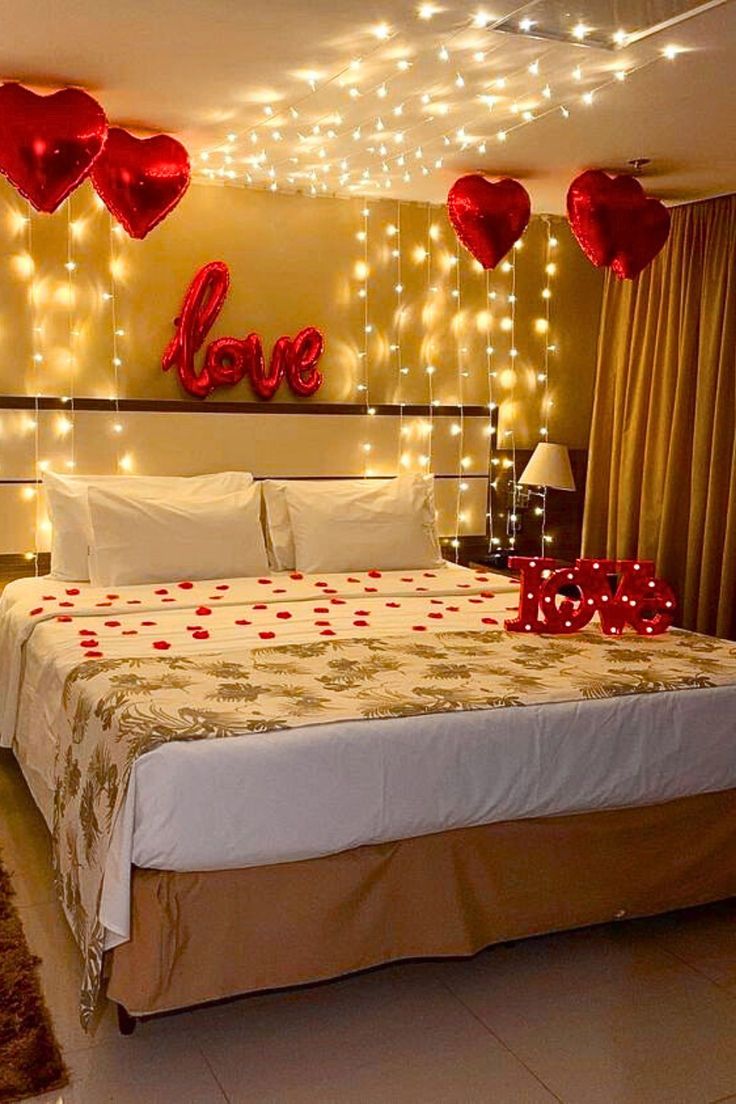 a bedroom decorated with lights and hearts on the wall