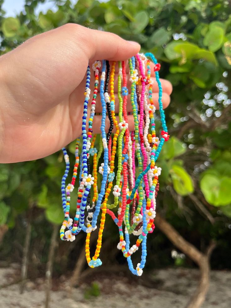 These are beautiful dainty and summery necklaces perfect to add to any jewelry stack you might already have! They come in many colors and patterns so check the according numbers to the colors to purchase your own. Hope you love them as much as I do! Please don't wear underwater on a daily basis as the colors might fade over time. Thank you for supporting my business! Summer Beaded Necklaces With Flower Charm As Gift, Summer Gift Beaded Necklace With Flower Charm, Multicolor Beaded Necklace With Flower Charm For Summer, Multicolor Round Beads Flower Necklace For Summer, Beaded Flower Necklace For Summer Gifts, Summer Flower Beaded Necklaces, Summer Flower Necklace With Tiny Beads, Summer Flower Necklace With Tiny Round Beads, Summer Beach Flower Necklace With Charm