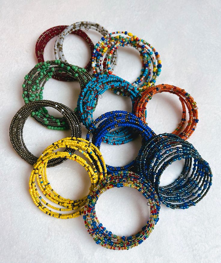 This stunning handmade adjustable beaded women's wrist bracelet from Kenya is a must-have for any lover of ethnic jewelry. The bracelet features beautiful sead beads and are crafted with care by local artisans. The bracelet is perfect for those who appreciate unique and authentic pieces of jewelry. It is made from high-quality materials and is sure to make a statement. Add a touch of Kenyan culture to your wardrobe with this beautiful Maasai women's bracelet. Traditional Adjustable Bangle With Colorful Beads, Spiritual Round Beaded Bracelets For Festivals, Artisan Beaded Bangle Bracelets For Festivals, Beaded Bangle Bracelet For Festivals, Festival Bangle Bracelet With Beads, Handmade Stretch Bangle Bracelet For Festival, Handmade Bangle Stretch Bracelet For Festivals, Traditional Handmade Adjustable Stretch Bracelet, Adjustable Traditional Stretch Bracelet For Festivals