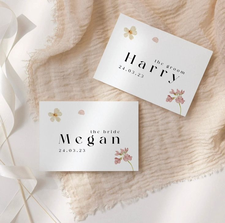 two white business cards with pink flowers on them and the words harry written in black ink