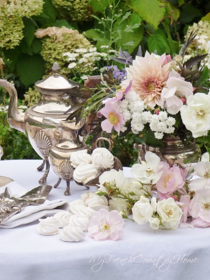 a table with flowers and silverware on it