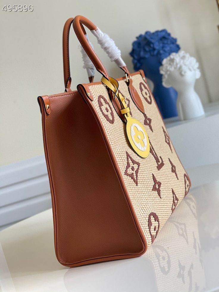 Description L.V OnTheGo MM Tote Bag Monogram Raffia Tan For Women, Women’s Handbags, Shoulder Bags 13.8in/35cm LV M57707 Rep 1:1 Perfect for travel or a day at the beach, the OnTheGo MM tote bag is made from Monogram Raffia with handles, shoulder strap, and gussets. Monogram Raffia is composed of recycled cotton and sustainably sourced viscose base with an embroidered Monogram Giant pattern. This tote has a removable bag charm in a contrasting color. 35 x 27 x 14 cm / 13.8 x 10.6 x 5.5 inches (Length x height x width) Tan Sustainable raffia-like woven textile Textile lining Gold-color hardware Large interior inside flat zipped pocket 2 inside pockets Raffia-like woven textile charm 2 long shoulder straps Handle: Double – Includes dust bag. – This product is of the best quality. Onthego Mm, Louis Vuitton Onthego, Louis Vuitton Mm, Tan Handbags, Embroidered Monogram, Hand Bags, Fendi Bags, Recycled Cotton, Dior Bag