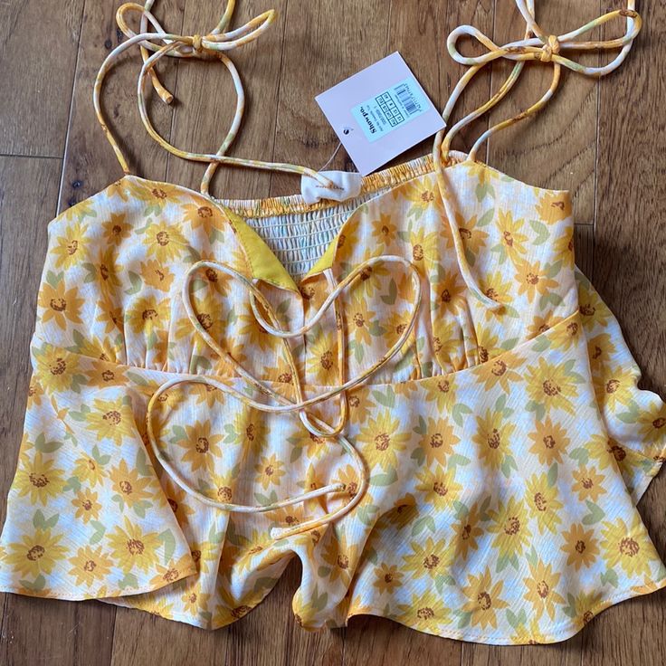 Tie Up Flowy Cropped Tank With Yellow Floral Pattern. Never Worn New With Tags Boutique Blouse Sleeveless Tops With Lemon Print For Vacation, Vacation Sleeveless Tops With Lemon Print, Lemon Print Summer Tops, Summer Vacation Tops With Lemon Print, Fitted Sunflower Print Top For Spring, Fitted Yellow Tops With Sunflower Print, Sunflower Print Beach Tops For Summer, Summer Beach Tops With Sunflower Print, Sunflower Print Tops For Summer Beach