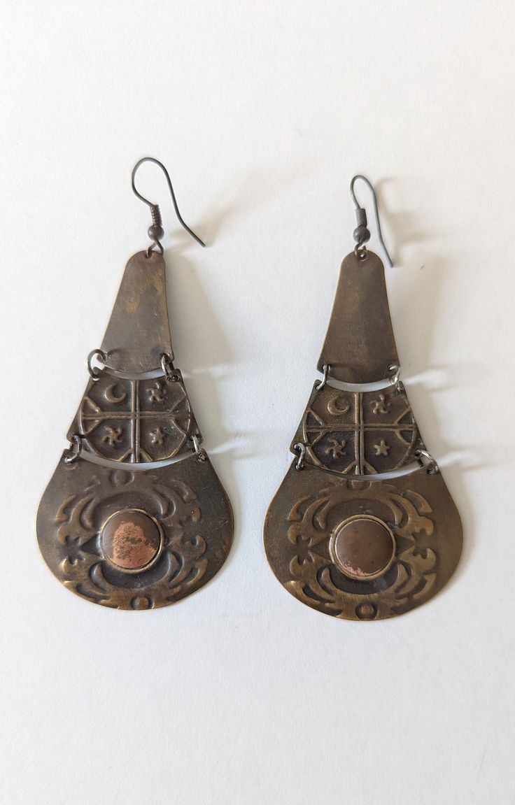 "Vintage Brass Earrings with punched design measures 2.5\" long x 1.5\" wide natural patina unsigned for more listings, please click here: https://www.etsy.com/shop/MonarkVintage Vintage condition usually means \"pre-loved\". We do, however try our best to show in the pictures and name in the description any imperfections beyond what is considered \"mild wear\". Vintage items are sold \"as is\" and we do not accept returns. If you have a question about an item or wish to see more photos, we will Vintage Bronze Teardrop Earrings, Handmade Vintage Bronze Plug Earrings, Handmade Bronze Vintage Plug Earrings, Vintage Handmade Copper Earrings, Vintage Copper Teardrop Earrings, Handmade Vintage Copper Earrings, Vintage Brown Earrings For Festivals, Vintage Teardrop Metal Earrings, Vintage Nickel-free Earrings For Festival