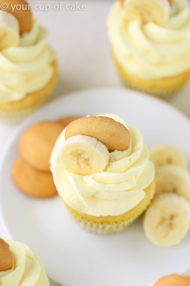 cupcakes with banana slices and cream frosting on a plate