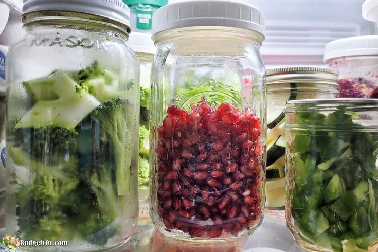 several jars filled with different types of vegetables