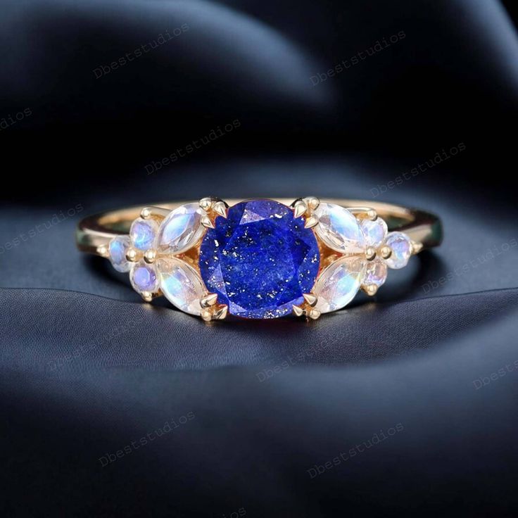 a ring with a blue stone surrounded by white and yellow opal stones on it