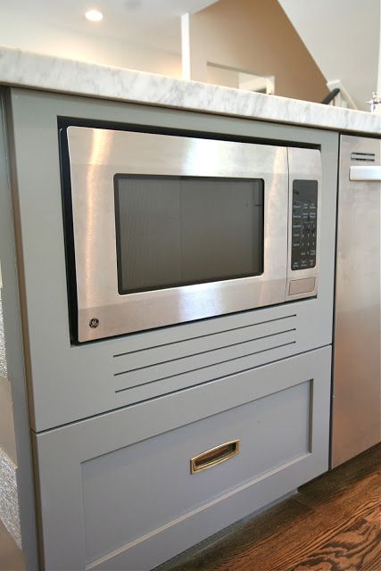 a kitchen with an oven and microwave built into the counter top in front of it