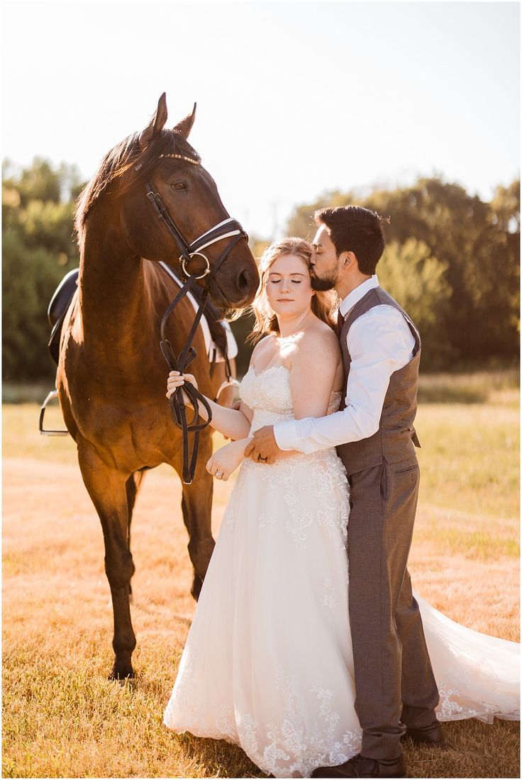 a bride and groom standing next to a horse