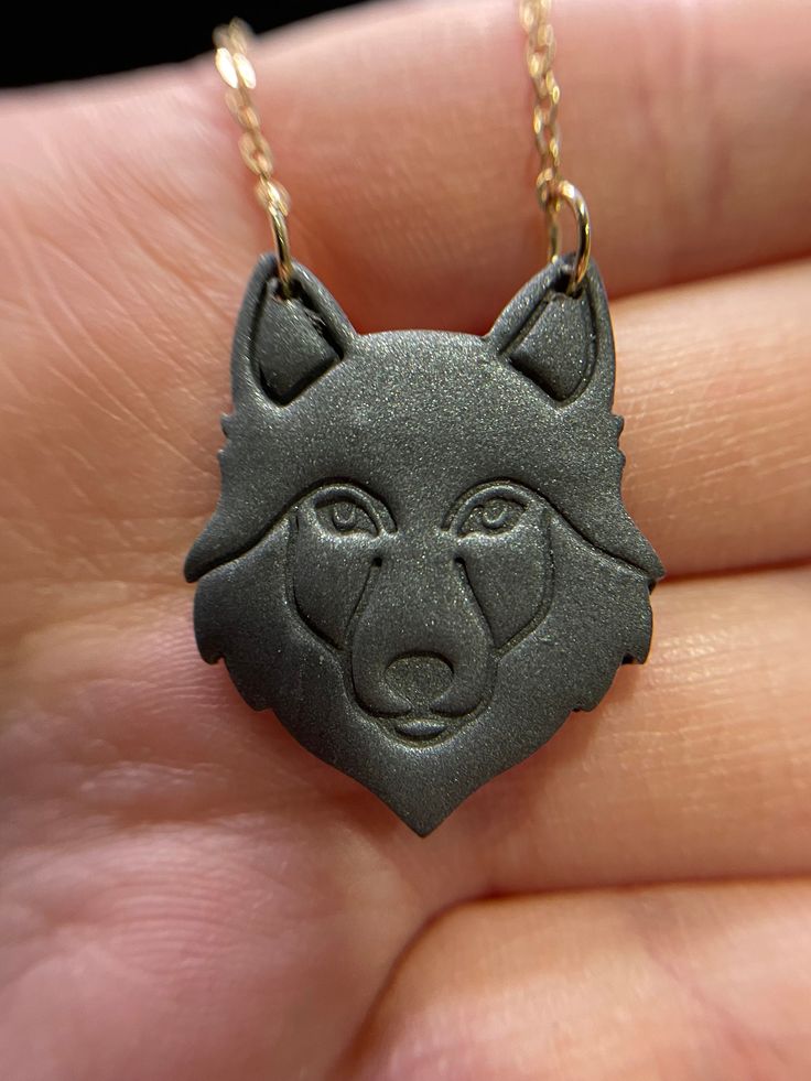 Necklace "Grey Polymer Clay Wolf Pendant" Add a touch of unique charm to your jewelry collection with our "Grey Polymer Clay Wolf Pendant" necklace. Featuring a striking wolf-shaped pendant, this piece combines artistic craftsmanship with elegant style. Chain Length: 22 inches (56 cm) + Extension Pendant Width: 2.6 cm Pendant Height: 3.2 cm Shape: Wolf Color: Grey Closure: Lobster Claw Weight: 4.50 g Material: Polymer Clay Nickel-Free Description: This necklace features a beautifully crafted wol Black Wolf Design Jewelry For Gift, Gray Pendant Jewelry For Gifts, Gray Pendant Jewelry As A Gift, Gray Pendant Necklace Gift, Clay Wolf, Wolf Pendant Necklace, Wolf Colors, Different Necklines, Wolf Pendant