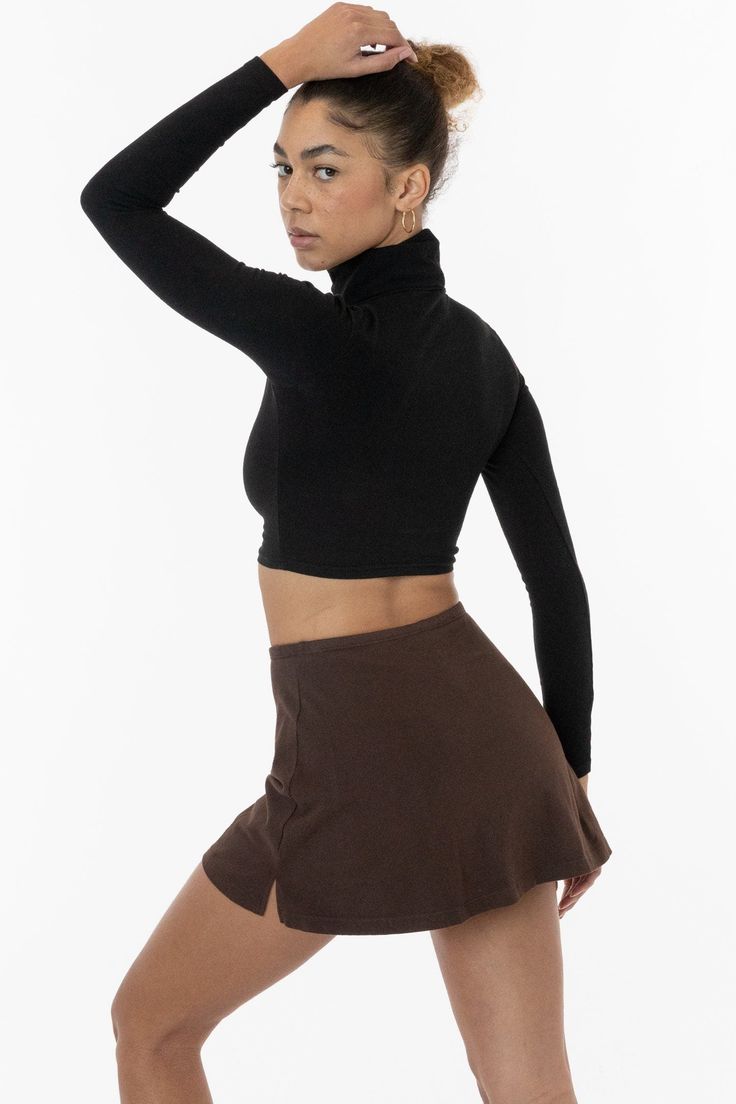 The Garment Dye Cheer Skort is made of our premium heavyweight cotton spandex and features a mid to high waist fit. This style features full, fitted shorts underneath so you can move around freely and a minimal 1/2" elastic waistband. Try pairing this skirt with a matching crop top or bodysuit for an athletic and sporty inspired look that shows off your figure. 2 side slits to this mini skort add a flirty finish. Made in Los Angeles, Calif. Our experienced sewers earn up to $25 an hour and no le Cheer Shorts, Skort Style, Fitted Shorts, Los Angeles Apparel, Comfortable Skirts, Pretty Shorts, Long Torso, Skirt Fits, Athletic Outfits