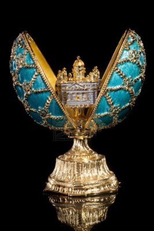 an ornate blue and gold clock on top of a golden pedestal