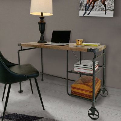 a computer desk with a laptop on top of it next to a chair and lamp