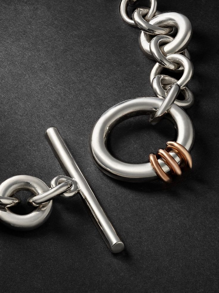 Spinelli Kilcollin's distinctive 'Atlantis' bracelet captures the brand's love for jewellery stacking with interlocking chain links that alternate in size and placement. It's cast from silver and characterised by three rose gold rings that coil around the central T-bar fastening. This product was Locally Made. Find out more about our Craftsmanship Code here.