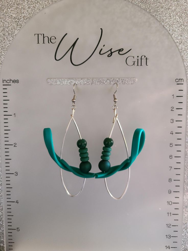 Hello & Welcome! In this listing you will find a unique, handcrafted, pair of wire teardrop statement earrings. Made using 16 gauge silver artistic wire, teal green flex strips, 8mm hunter green rubberized beads, forest green silicone spacer beads, 6mm dark green acrylic beads, nickel free stainless steel jump rings & earring hooks, and lots of love. They are comfortable to wear. You will receive the exact pair that is shown in the photos. Free gift wrapping is available. If you're sending them as a gift, please mark the gift option or send me a message. If you have any questions, feel free to send me a message & I'll be happy to assist you.  Spice up your jewelry collection with this amazing pair of handcrafted earrings. Thanks for taking a look & have yourself a beautiful day!♥ Green Teardrop Hoop Earrings, Green Metal Dangle Teardrop Earrings, Nickel-free Green Teardrop Hoop Earrings, Green Teardrop Nickel Free Hoop Earrings, Green Teardrop Nickel-free Hoop Earrings, Green Wire-wrapped Dangle Hoop Earrings, Green Wire Wrapped Metal Earrings, Green Wire Wrapped Dangle Hoop Earrings, Green Metal Teardrop Earrings