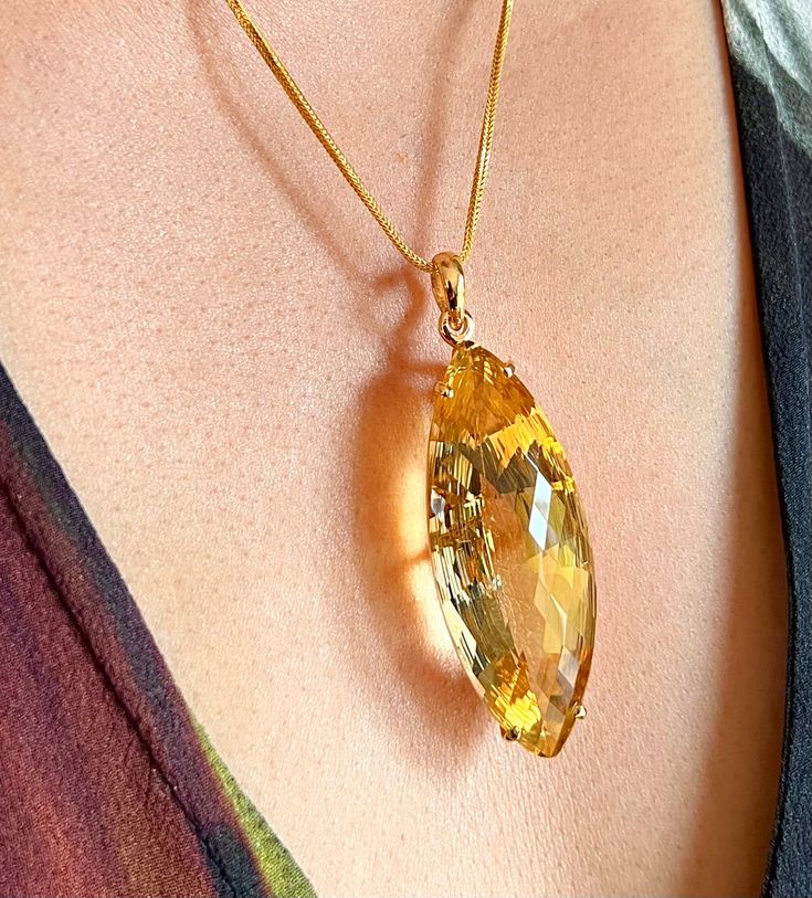 A Gold cocktail pendant features a large 75 Carats yellow Citrine.  An Unheated Natural Citrine gemstone of custom cut in marquise shape  . The pendant has been hand crafted in 10K  Yellow Gold, but only UK hallmark it as 9K. It has been beautifully hand made to showcases this large gemstone. It is set in 4 prongs basket setting with simple lines combine with big bold gemstone, a classic design with contemporary look.  Only 1 is available. Limited Edition. Cut      - Marquise Custom Cut Clarity Large Gemstone Pendant, Cocktail Necklace, Faberge Jewelry, Blue Sapphire Pendant, Pretty Accessories, Heritage Jewellery, Citrine Jewelry, Basket Setting, Citrine Pendant