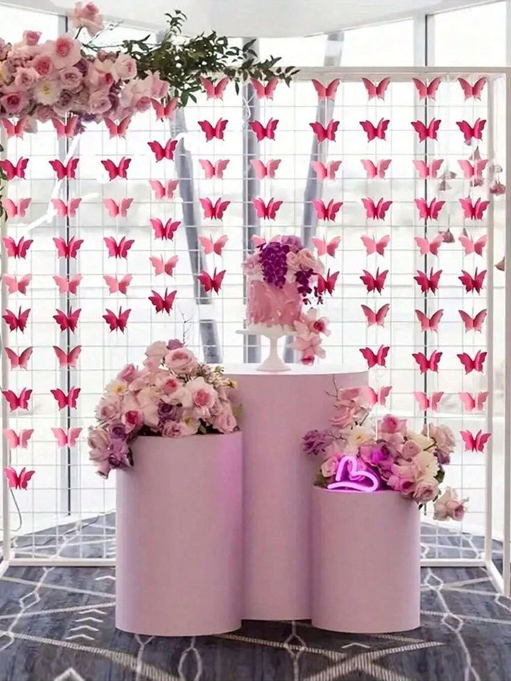 three pink vases with flowers and butterflies on them