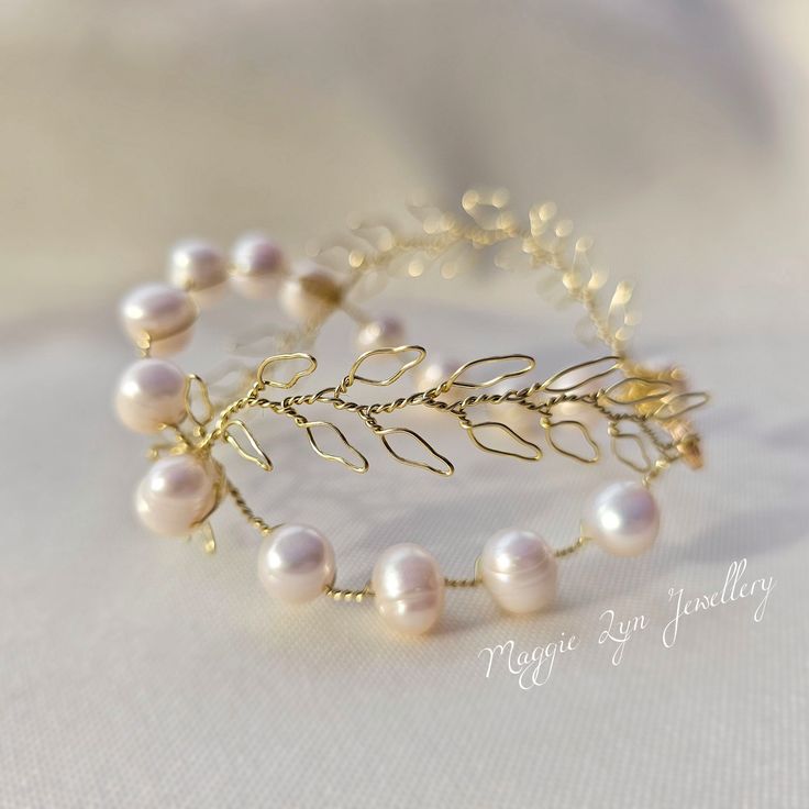 This Handmade Freshwater Pearl Bracelet is an exquisite piece of jewelry perfect for any special occasion. Its chunky pearls and gold leaf design add a touch of elegance and uniqueness to any bridal or wedding jewelry collection. The bracelet is intricately crafted with genuine crystals, freshwater pearls, and handcrafted gold leaves which make it stand out from the rest.  The bracelet comes in a beautiful gold cuff design that enhances its beauty even more. It is made from high-quality material Gold Bridal Jewellery, Gold Arm Band, Gold Pearl Bracelet, Gold Cuff Bracelet, Chunky Pearls, Cuff Design, Wedding Jewellery Collection, Gold Armband, Leaf Bracelet