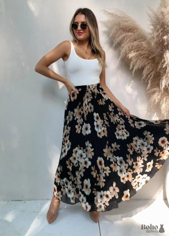 This flirty black dress is perfect for a boho-inspired look. The loose, flowy silhouette and delicate floral print make it ideal for summertime style. Pair with sandals or wedges and statement jewelry to complete the ensemble. This versatile piece can be dressed up or down depending on your mood and occasion. You'll love the freedom of movement afforded by the comfortable fabric blend, making this an essential addition to your wardrobe.