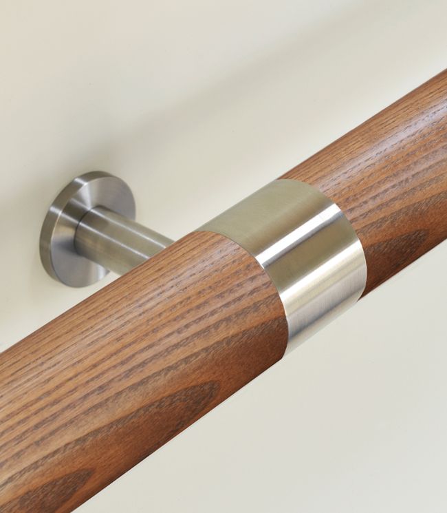 a close up of a wooden handle on a white wall with wood and metal accents