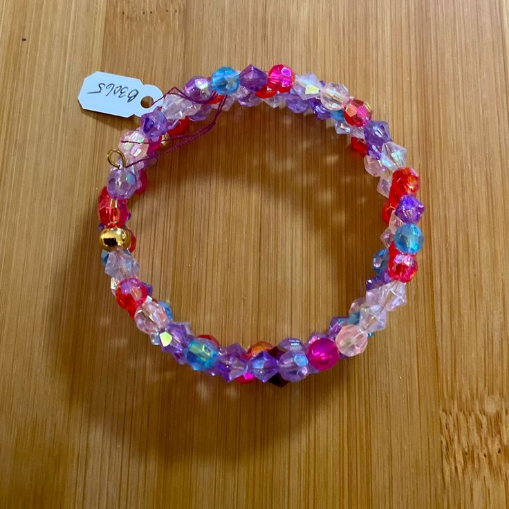 This Is A Handcrafted Beaded Wrap Bracelet. It Has 3 Coils. The Beads Are Crystals Accented With Stainless Steel Gold Beads. They Are 6mm In Colors Of Pink, Lilac, Purple, Blue, Deep Pink. The Beads Are Strung On Remembrance Memory Wire. It Fits A Small To Medium Size Wrist. The Bracelet Can Be Worn To Dress Up Or To Dress Down. It Is Suitable For Work And Play. It Is Gorgeous And Will Look Good With Denim As Well As Satin. It Is Suitable For Girls, Teens, Adults And Seniors. It Is Easy To Put O Trendy Pink Stretch Bracelet With Faceted Beads, Faceted Beaded Bracelets For Party, Pink Beaded Bracelets For Spring Festival, Faceted Beaded Bracelet For Party, Spring Festival Pink Beaded Bracelets, Spring Party Blue Bracelets, Adjustable Crystal Bracelet With Colorful Beads For Festival, Adjustable Multicolor Bracelets For Party, Purple Stretch Bracelet With Round Beads For Party