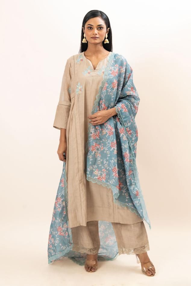 Beige A-line kurta with placement floral embroidery. Paired with a pant and dupatta with all over floral print. Comes along with an inner.
Components: 4
Pattern: Hand Embroidery, Print
Type Of Work: Floral
Neckline: V Neck
Sleeve Type: Three Quarter Sleeves
Fabric: Kurta: Chanderi, Pant: Bamber Silk, Dupatta: Kota Doria, Lining: Mul Cotton
Color: Beige
Other Details: 
Separate inner
Occasion: Puja - Aza Fashions Semi-stitched Slub Silk Salwar Kameez With Floral Embroidery, Unstitched Chanderi Sharara With Printed Motifs, Spring Anarkali Set With Straight Kurta And Dupatta, Cotton Silk Sharara With Printed Motifs, Spring Chanderi Salwar Kameez With Printed Motifs, Chanderi Salwar Kameez With Printed Motifs For Spring, Slub Silk Palazzo Set With Straight Kurta And Dupatta, Slub Silk Palazzo Set With Dupatta And Straight Kurta, Cotton Silk Palazzo Set With Dupatta And Straight Kurta