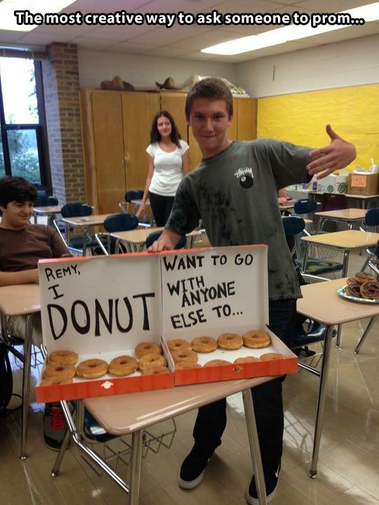 a man standing next to a table with donuts on it