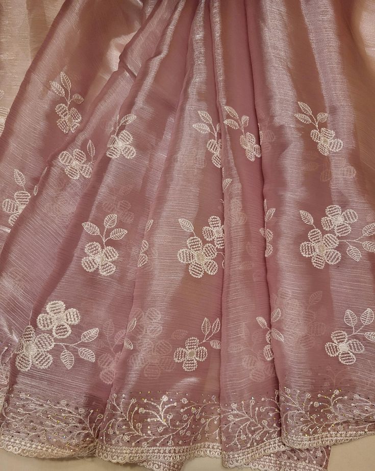 A one-of-a-kind pink organza saree with white floral stitching and silver stones that can be perfect for any event (receptions, formals, parties, etc.)! This saree has a sheer look due to the trendy jimmy choo material. A blouse piece is included (last image). Festive Pink Organza Saree, Pink Organza Saree For Festivals, Festival Pink Organza Saree, Elegant Semi-stitched Pink Embroidered Fabric, Elegant Pink Semi-stitched Embroidered Fabric, Pink Tissue Silk Saree With Dori Work, Pink Raw Silk Saree For Party, Elegant Pink Saree With Zari Work, Pink Anarkali Organza Saree